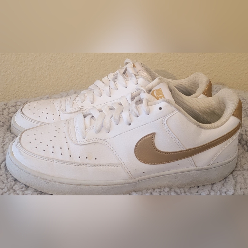 Nike White Sneakers with Gold Swoosh Accent
